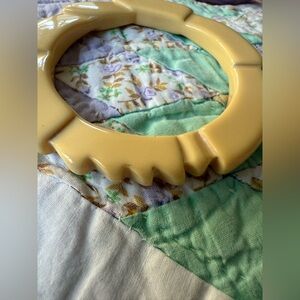 A Carved Butterscotch Bakelite Bangle Bracelet from the Art Deco period